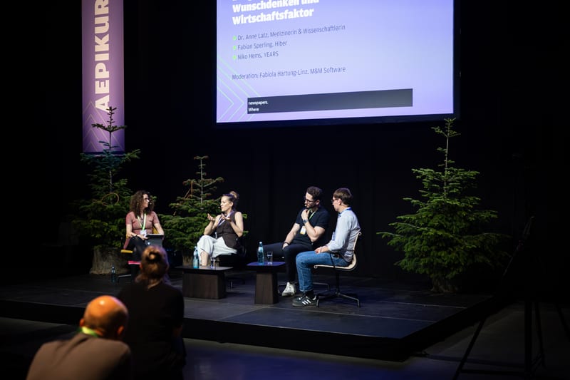 Niko Hems as a panellist at the AEPIKUR conference, on stage with three other speakers